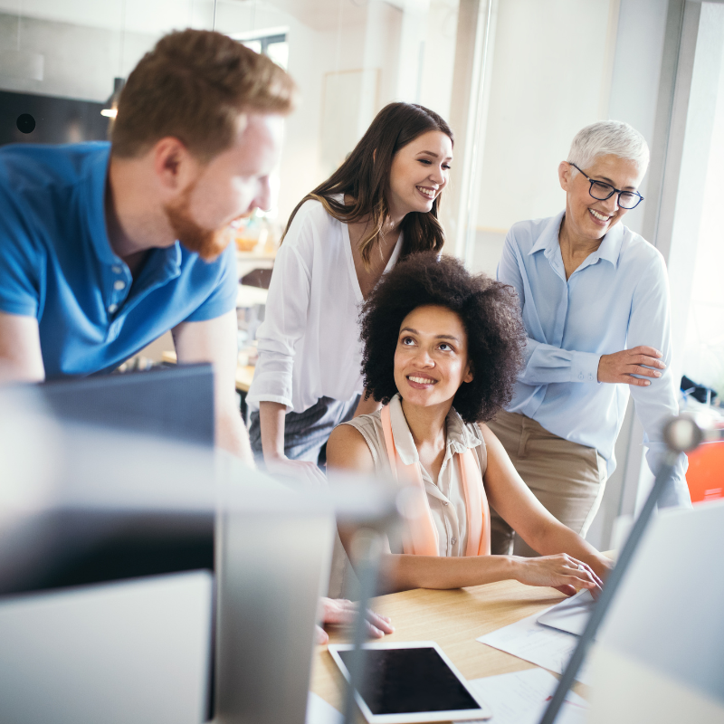 A group of office workers looking at spreadsheets